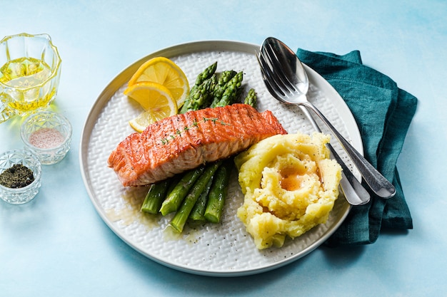 Grilled salmon with fresh asparagus and mashed potatoes on a plate. healthy food on the table