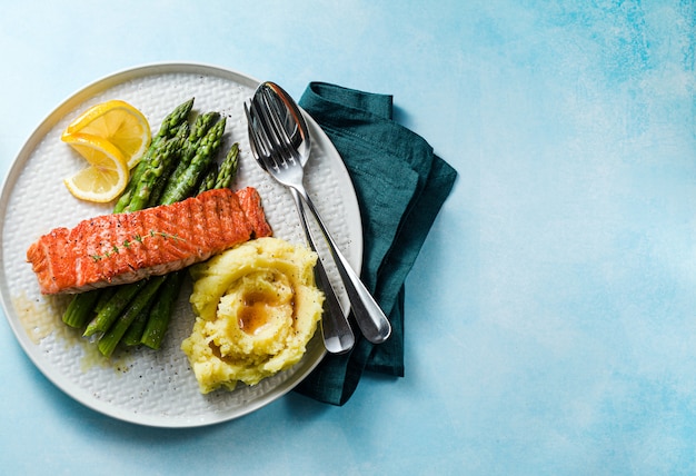 Grilled salmon with fresh asparagus and mashed potatoes on a plate. healthy food on the table