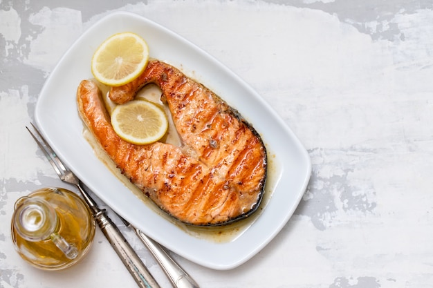 Grilled salmon with lemon on dish