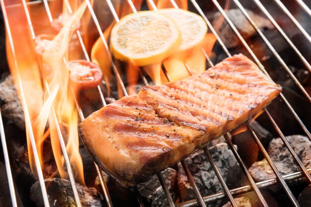 Grilled salmon with lemon on the flaming