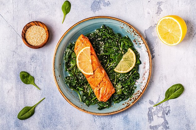 Grilled salmon with spinach, top view.