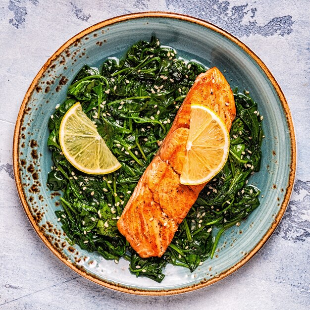 Grilled salmon with spinach, top view.