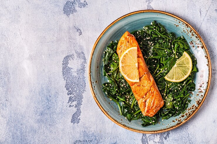 Grilled salmon with spinach, top view.