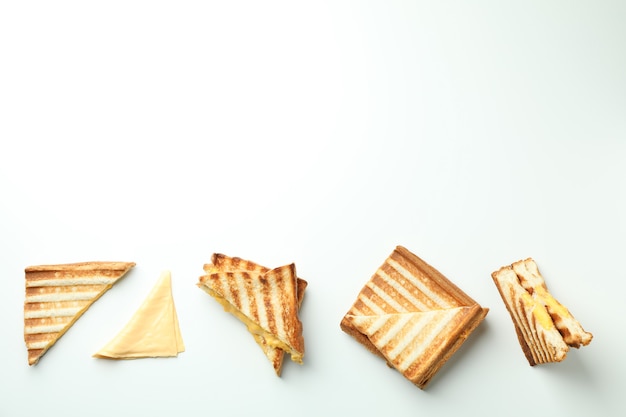 Grilled sandwiches with cheese on white background