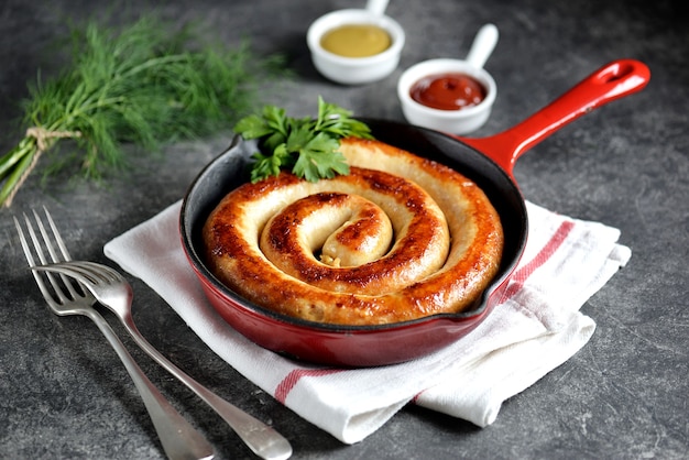 Grilled sausage in a cast iron pan