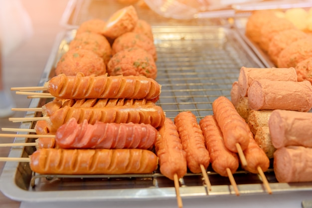 Grilled sausage on the flaming grill prepared  for sale at local market