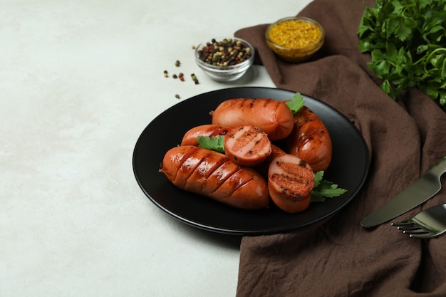 grilled sausage on white textured surface