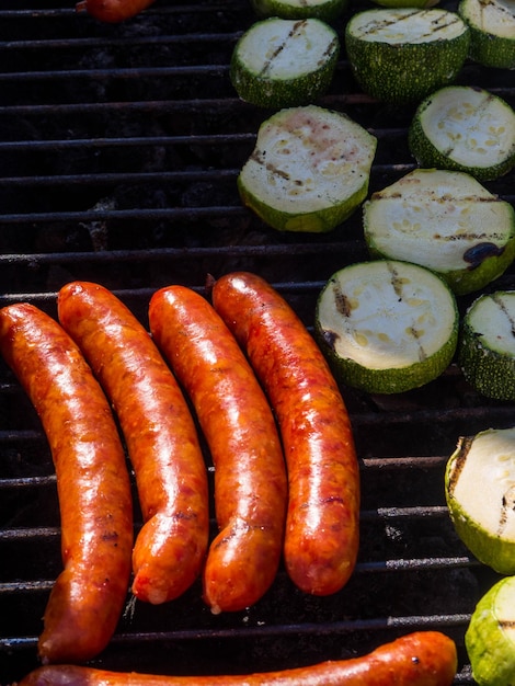 Grilled sausages cheese sausages fry on the grill with zucchini