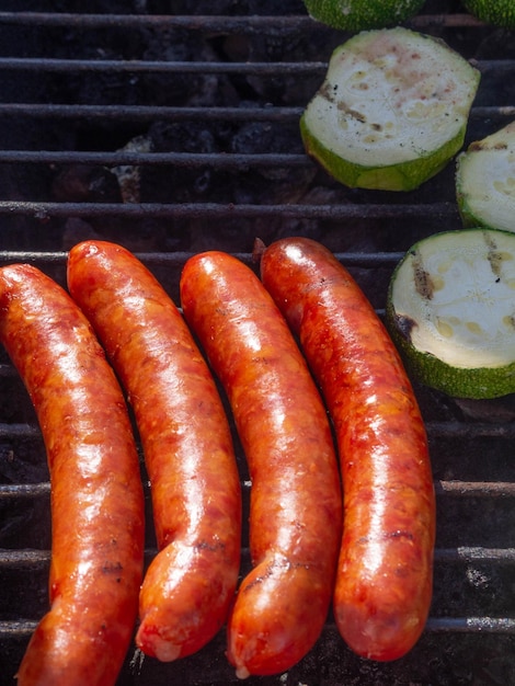 Grilled sausages cheese sausages fry on the grill with zucchini