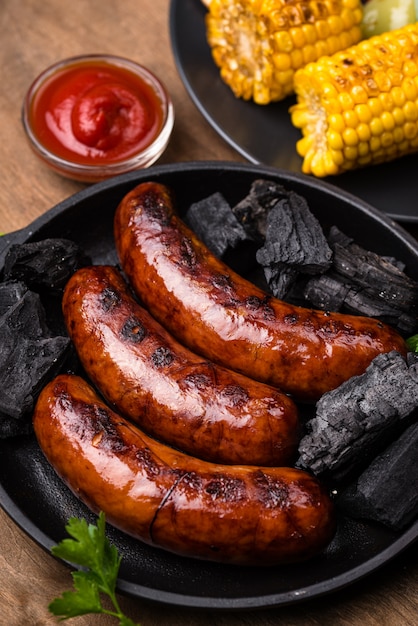 Grilled sausages, meat, and vegetables.