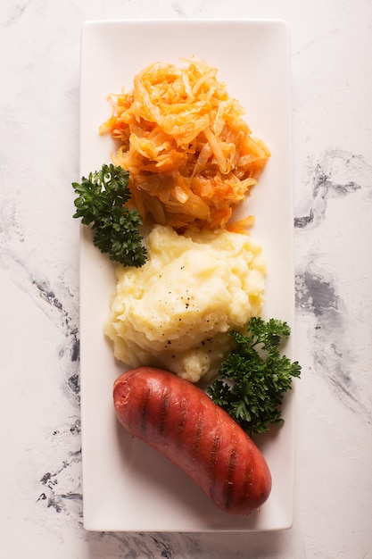 Grilled sausages and potatoes with glass of beer