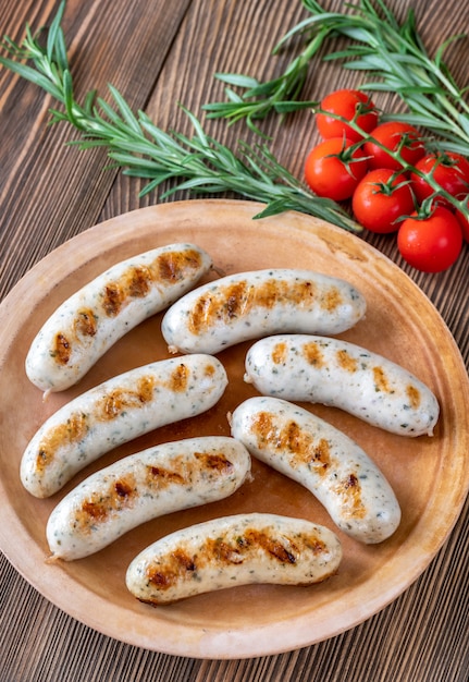 Grilled sausages on rustic plate