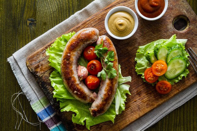 Grilled sausages served on wood board