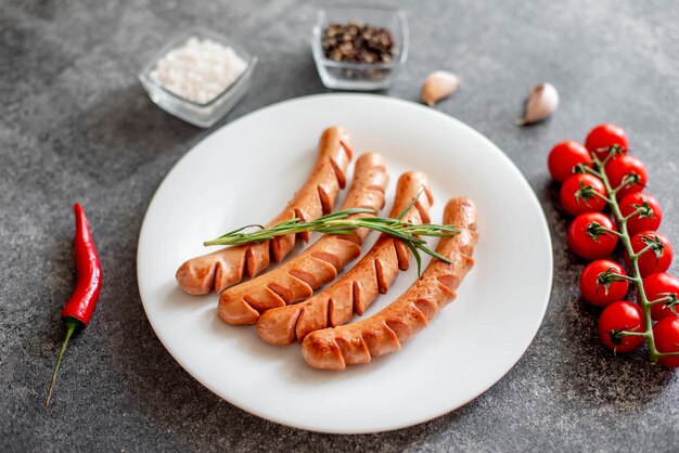 grilled sausages on stone background