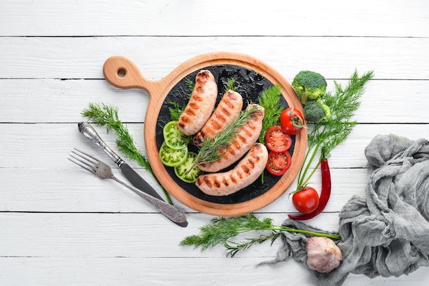 Grilled sausages on a white wooden background background Meat Top view Free copy space