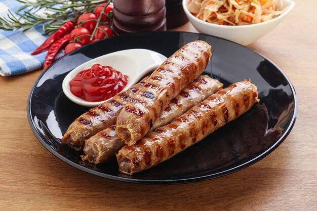 Grilled sausages with cabbage and sauce