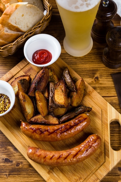 Grilled sausages with roast potato with spices