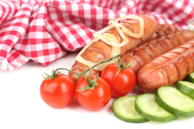 Grilled sausages with vegetables close up