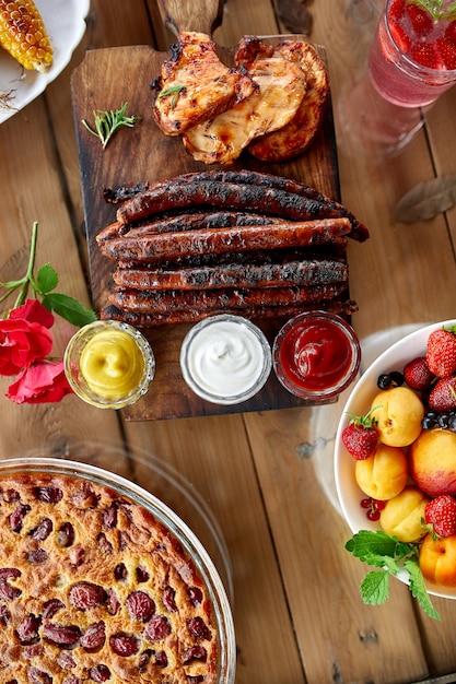 Grilled sausages on a wooden board on the table