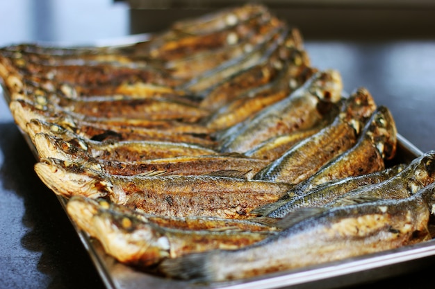 Grilled sea bass on a metal baking sheet