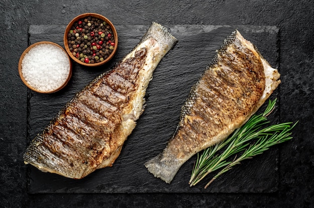 grilled sea bass with spices on a stone table