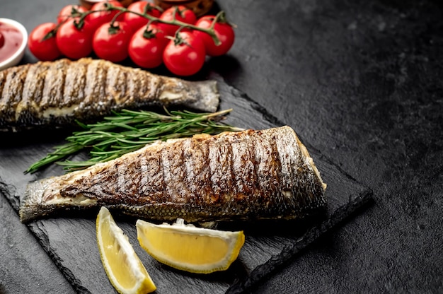 grilled sea bass with spices on a stone table