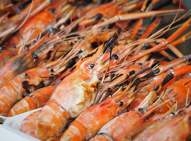 Grilled shrimp for sale on street market. Fresh barbecue prawns in seafood market.