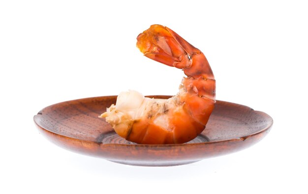 grilled shrimp on a wooden plate isolated on white background