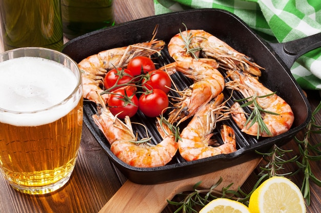 Grilled shrimps on frying pan and beer