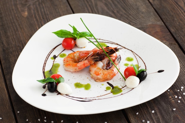 Grilled shrimps on white plate