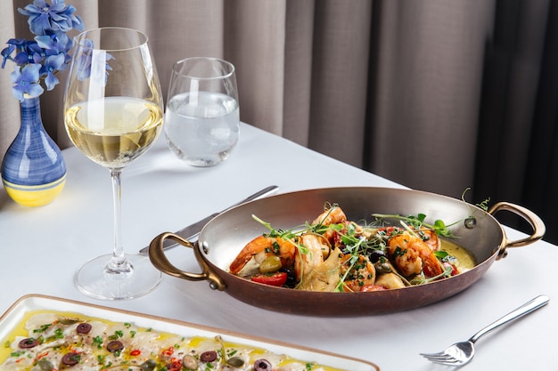 Grilled shrimps with vegetables in a metal bowl