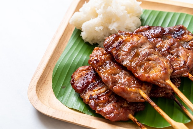 grilled skewered milk pork with white sticky rice