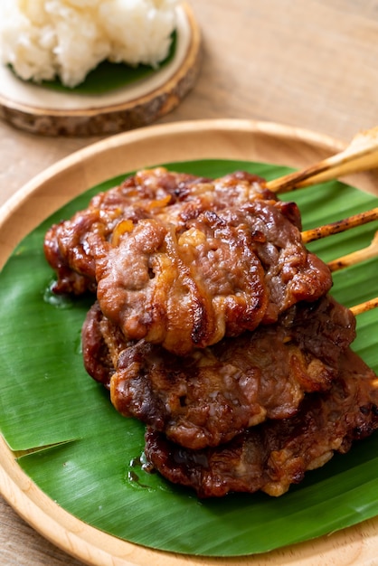 grilled skewered milk pork with white sticky rice
