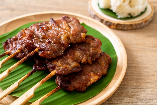 grilled skewered milk pork with white sticky rice