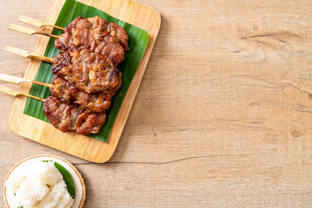 grilled skewered milk pork with white sticky rice