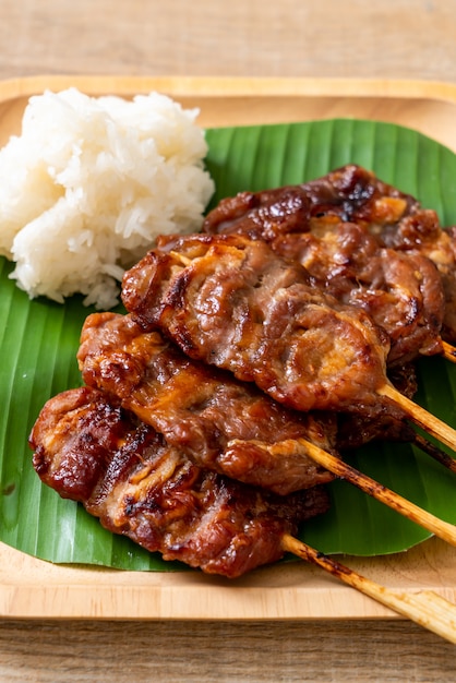 grilled skewered milk pork with white sticky rice