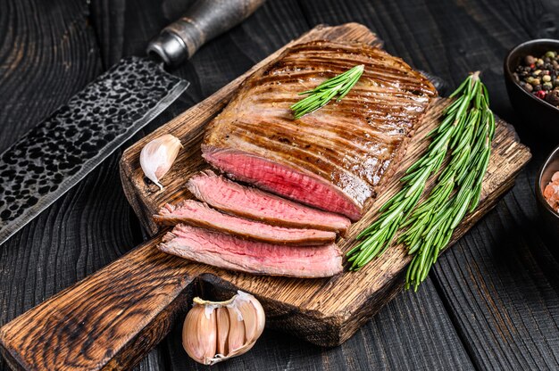 Grilled skirt beef meat steak on a wooden cutting board