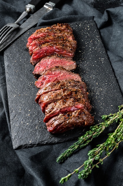 Grilled steak on a black board