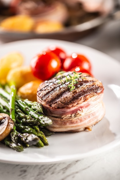 Grilled steak served on a plate with vegetables.