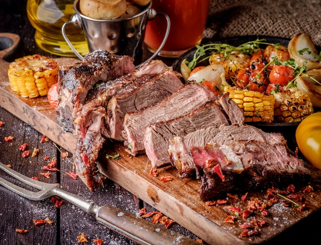 Grilled steak sliced on a cutting board.