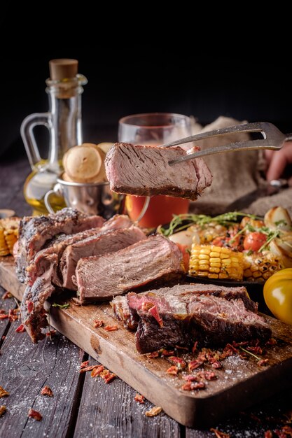 Grilled steak sliced on a cutting board.