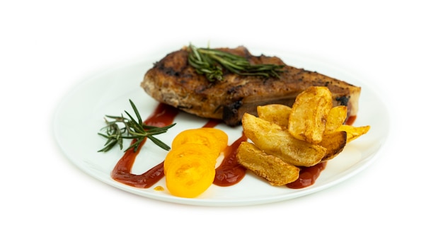 Grilled steak with baked potatoes and fresh yellow tomatoes