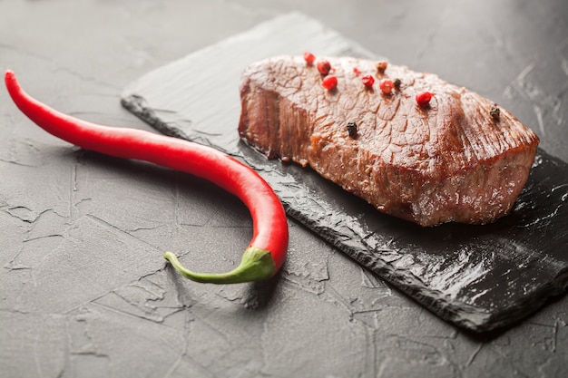 Grilled steak with chili on the black stone