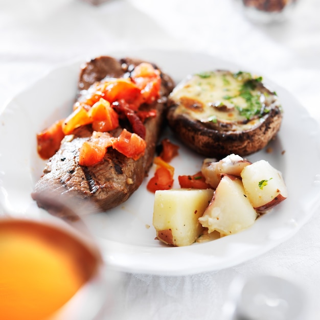 Grilled steak with potatoes and stuffed mushroom