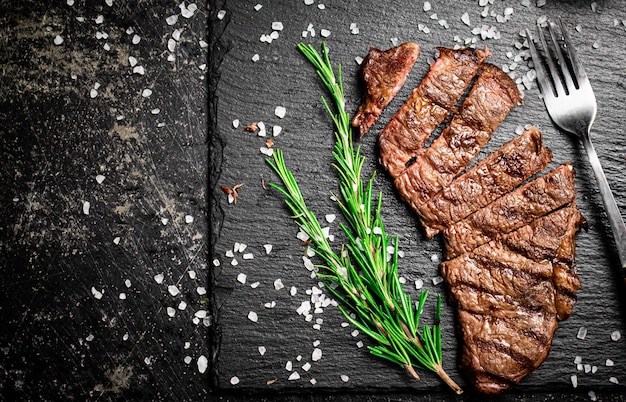 Grilled steak with a sprig of rosemary