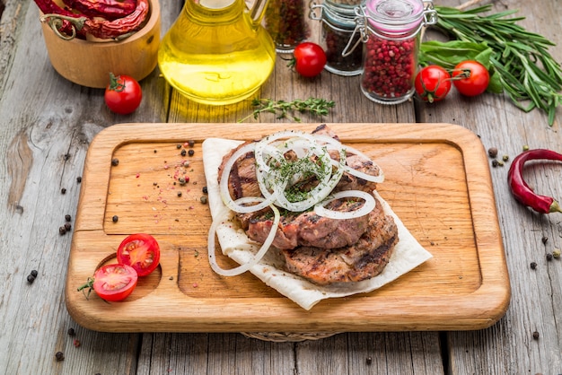 Grilled steaks on wood, beef steak