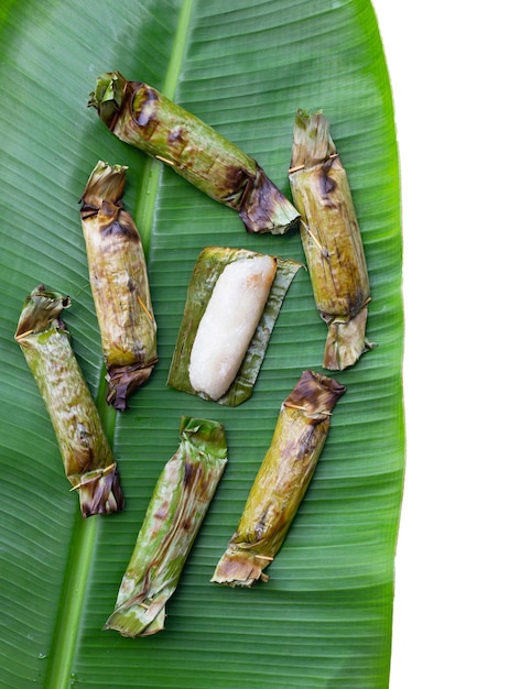 Grilled sticky rice in banana leaves with banana filling