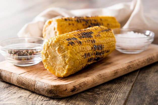 Grilled sweet corn on wooden table