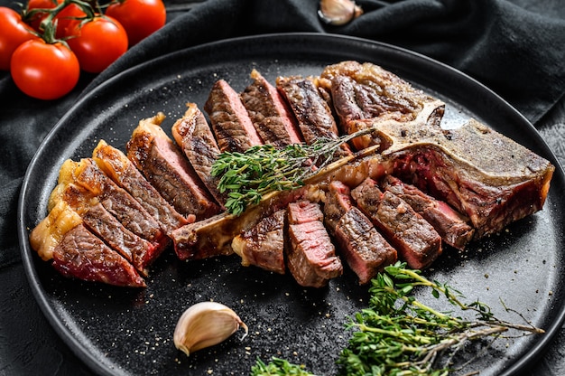 Grilled t-bone steak on a black plate