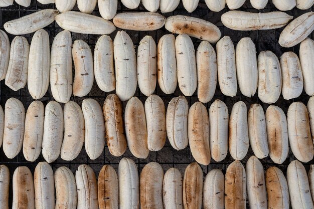 Grilled Thai banana at street food market in Thailand, close up. Fried banana, delicious street food.